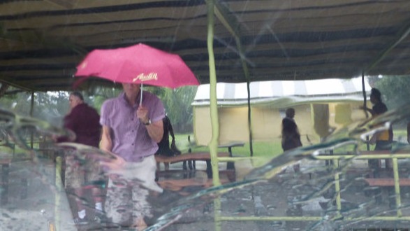 Austin car club umbrella getting a real workout in the rain